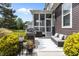 Outdoor patio featuring a screened porch, grill, sofa, and beautiful landscaping at 1508 Heritage Reserve Ct, Wake Forest, NC 27587