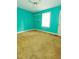 Bright bedroom with turquoise walls, carpet flooring, and a window at 1513 Western Ave, Rocky Mount, NC 27804
