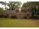 Charming brick home with manicured lawn, mature trees, and inviting curb appeal at 1513 Western Ave, Rocky Mount, NC 27804