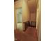 Hallway with carpet, view into an adjacent room with a ceiling fan at 1513 Western Ave, Rocky Mount, NC 27804
