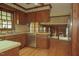 Kitchen with stainless steel dishwasher, wood cabinets, and view into a living room at 1513 Western Ave, Rocky Mount, NC 27804