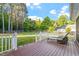 Backyard featuring a wood deck with patio furniture, grass, and a wood fence in the background at 1819 Umstead Rd, Durham, NC 27712