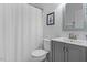 Bathroom featuring a shower with curtain, toilet and vanity with mirror and sink at 1819 Umstead Rd, Durham, NC 27712