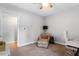 Bright bedroom with a ceiling fan, neutral paint, and floral armchair at 1819 Umstead Rd, Durham, NC 27712