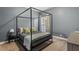 Bedroom featuring a canopy bed, grey walls, neutral carpet and a side table with lamp at 1819 Umstead Rd, Durham, NC 27712