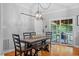 View of dining table and chairs, sliding barn door, and outdoor access at 1819 Umstead Rd, Durham, NC 27712