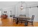 Elegant dining space with hardwood flooring, a rustic table and a sliding barn door adding character and charm at 1819 Umstead Rd, Durham, NC 27712