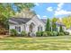 Inviting home exterior showcases lush green lawn, mature trees, and meticulously maintained landscaping enhancing its curb appeal at 1819 Umstead Rd, Durham, NC 27712