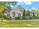 Charming home featuring manicured landscaping, a well-maintained lawn and elegant front entry with classic architectural details at 1819 Umstead Rd, Durham, NC 27712