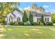 Beautiful home exterior displaying a perfectly manicured lawn and decorative shrubs that add to its inviting appeal at 1819 Umstead Rd, Durham, NC 27712