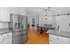 Bright kitchen with stainless fridge, white cabinets, and adjacent dining area at 1819 Umstead Rd, Durham, NC 27712