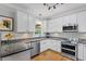 Bright kitchen features white cabinets, granite countertops, and stainless appliances at 1819 Umstead Rd, Durham, NC 27712