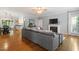 Open-concept living area featuring hardwood floors, a cozy fireplace, and a seamless flow into the dining and kitchen areas at 1819 Umstead Rd, Durham, NC 27712