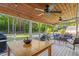 Covered patio featuring a wood ceiling with fan and lights, and an outdoor seating area at 1819 Umstead Rd, Durham, NC 27712