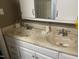 Bathroom featuring double sinks, ample counter space, and white cabinets for storage at 2037 Swepsonville Rd, Graham, NC 27253