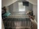 Attic bedroom with a comfortable bed, natural light, and cozy carpet at 2037 Swepsonville Rd, Graham, NC 27253