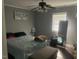 Cozy bedroom featuring a ceiling fan, window, comfortable bed, and decorative accents at 2037 Swepsonville Rd, Graham, NC 27253