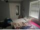 Bedroom with a twin bed, natural light from the window and closet storage at 2037 Swepsonville Rd, Graham, NC 27253