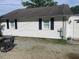 Exterior view of the home with white siding, black shutters and a grill at 2037 Swepsonville Rd, Graham, NC 27253