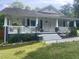 Inviting front porch with white railings and a welcoming entrance at 2037 Swepsonville Rd, Graham, NC 27253