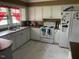 Bright kitchen featuring white cabinets, modern appliances, and ample counter space at 2037 Swepsonville Rd, Graham, NC 27253