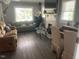 Relaxing living room featuring comfortable seating, a fireplace, and natural light from the windows at 2037 Swepsonville Rd, Graham, NC 27253