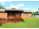 Backyard patio attached to a brick home offers a cozy outdoor space with a view of the sky at 2071 Meadow Ln, Graham, NC 27253