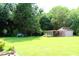 Spacious backyard featuring shed, ample green space, and flourishing trees at 2071 Meadow Ln, Graham, NC 27253