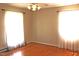 Bright bedroom with hardwood floors, neutral walls, and lots of natural light from two large windows at 2071 Meadow Ln, Graham, NC 27253