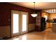 Open dining area adjacent to the kitchen, showcasing patterned wallpaper and access to the exterior at 2071 Meadow Ln, Graham, NC 27253