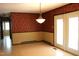 Dining area featuring patterned wallpaper, linoleum floors, and a view of the adjacent rooms at 2071 Meadow Ln, Graham, NC 27253