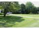 Long driveway leading to the house with a large lawn and mature trees on either side at 2071 Meadow Ln, Graham, NC 27253