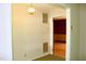 Inviting entryway with neutral walls, lighting fixture, and an open doorway to a room with patterned wallpaper at 2071 Meadow Ln, Graham, NC 27253