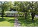 Charming single-story brick home with a well-manicured front yard and mature trees at 2071 Meadow Ln, Graham, NC 27253
