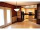 Charming kitchen with warm-toned cabinets, dark countertops, and a view of the adjacent dining area at 2071 Meadow Ln, Graham, NC 27253