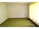Spacious living room with green carpeting, radiator, and a large window providing natural light at 2071 Meadow Ln, Graham, NC 27253