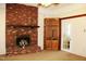 Inviting living room with a brick fireplace, built-in shelving, and bright natural light at 2071 Meadow Ln, Graham, NC 27253