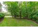 Well-maintained lawn with mature trees providing natural privacy at 2121 Vecchio Ln, Apex, NC 27502