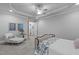 Comfortable bedroom features a sitting area, tray ceilings, and ensuite access at 2121 Vecchio Ln, Apex, NC 27502