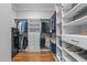 Walk-in closet with custom shelving and hardwood floors providing storage solutions at 2121 Vecchio Ln, Apex, NC 27502