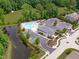 Aerial view of community pool, pool house, parking, and pond at 2121 Vecchio Ln, Apex, NC 27502