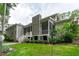 Charming home exterior with stone chimney, screened porch, and beautifully landscaped yard at 2121 Vecchio Ln, Apex, NC 27502