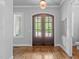 Bright foyer with hardwood floors and beautiful double front doors at 2121 Vecchio Ln, Apex, NC 27502