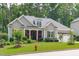 Charming single-story home featuring a manicured lawn and inviting curb appeal in a wooded neighborhood at 2121 Vecchio Ln, Apex, NC 27502