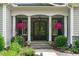 Inviting front porch with stone accents and elegant flower arrangements at 2121 Vecchio Ln, Apex, NC 27502