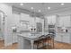 Stunning kitchen features a large granite island, stainless steel appliances, and ample counter space at 2121 Vecchio Ln, Apex, NC 27502