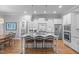 Spacious kitchen with granite island, stainless steel appliances, and modern pendant lighting at 2121 Vecchio Ln, Apex, NC 27502