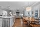 Open-concept kitchen and living room with breakfast table and built-in shelves at 2121 Vecchio Ln, Apex, NC 27502