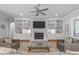 Cozy living room with a fireplace and built-in shelving units at 2121 Vecchio Ln, Apex, NC 27502