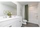 Bright bathroom features a double vanity, framed mirror, and a shower and tub combination with a green shower curtain at 218 Macon Lake Drive # 43, Apex, NC 27523